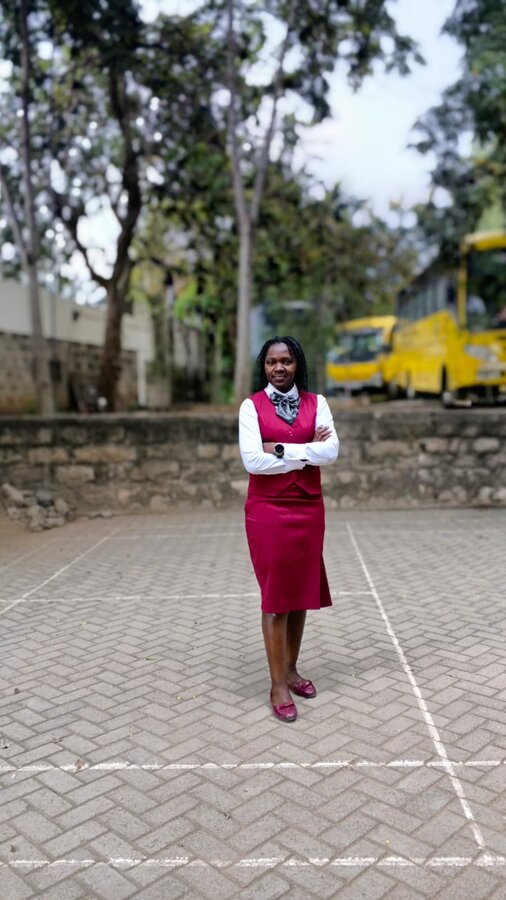 Founder Victoria Wakoli standing outside a partner school